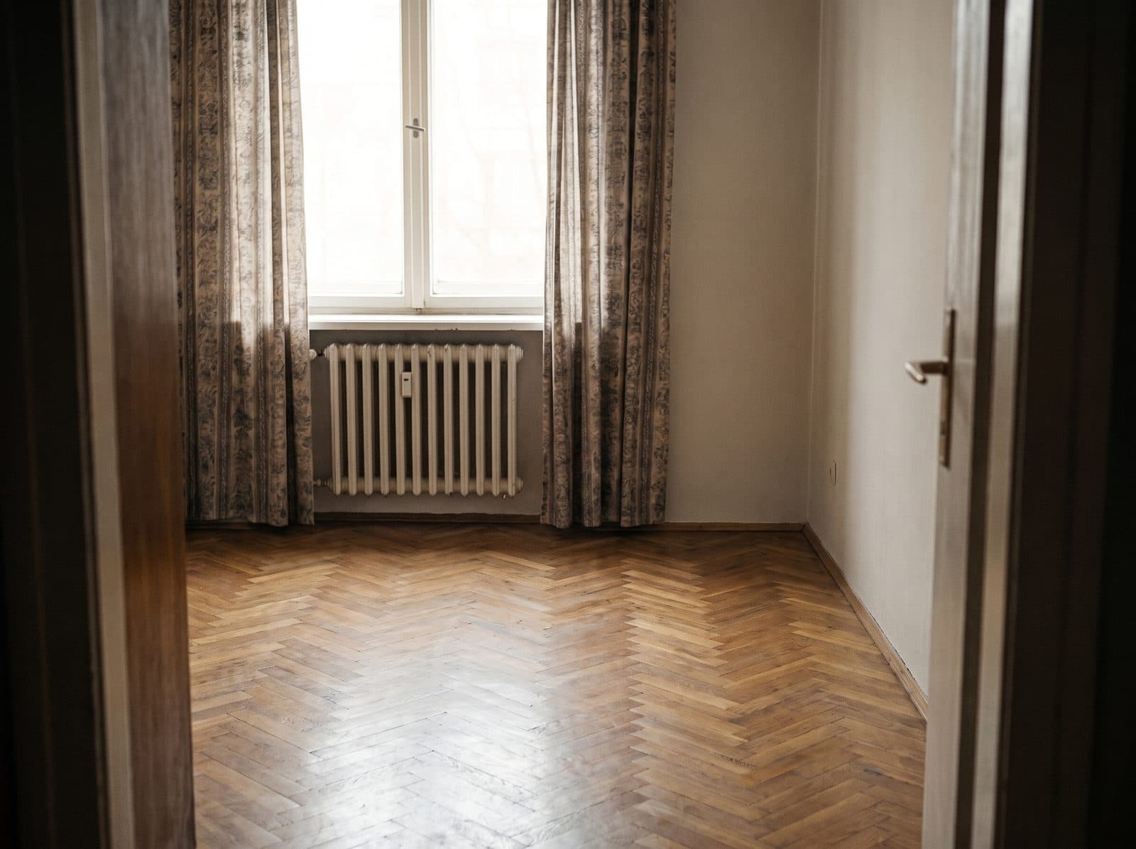 The same bedroom, empty, cleaned and lit.